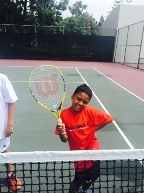 Junior tennis player practicing at the net