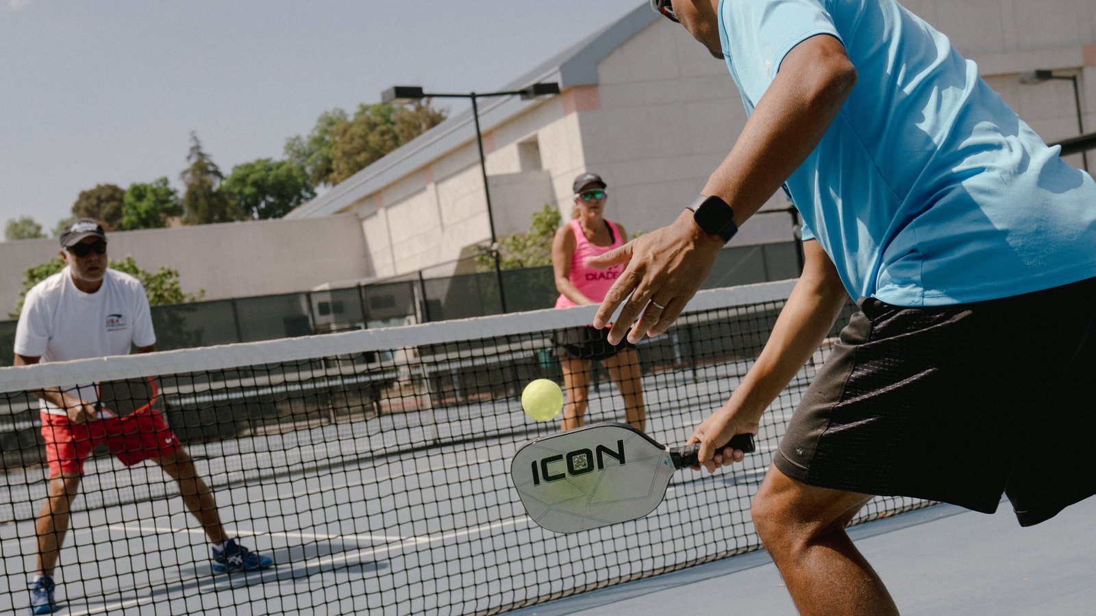 Pickleball player dinking at the kitchen line during a doubles point